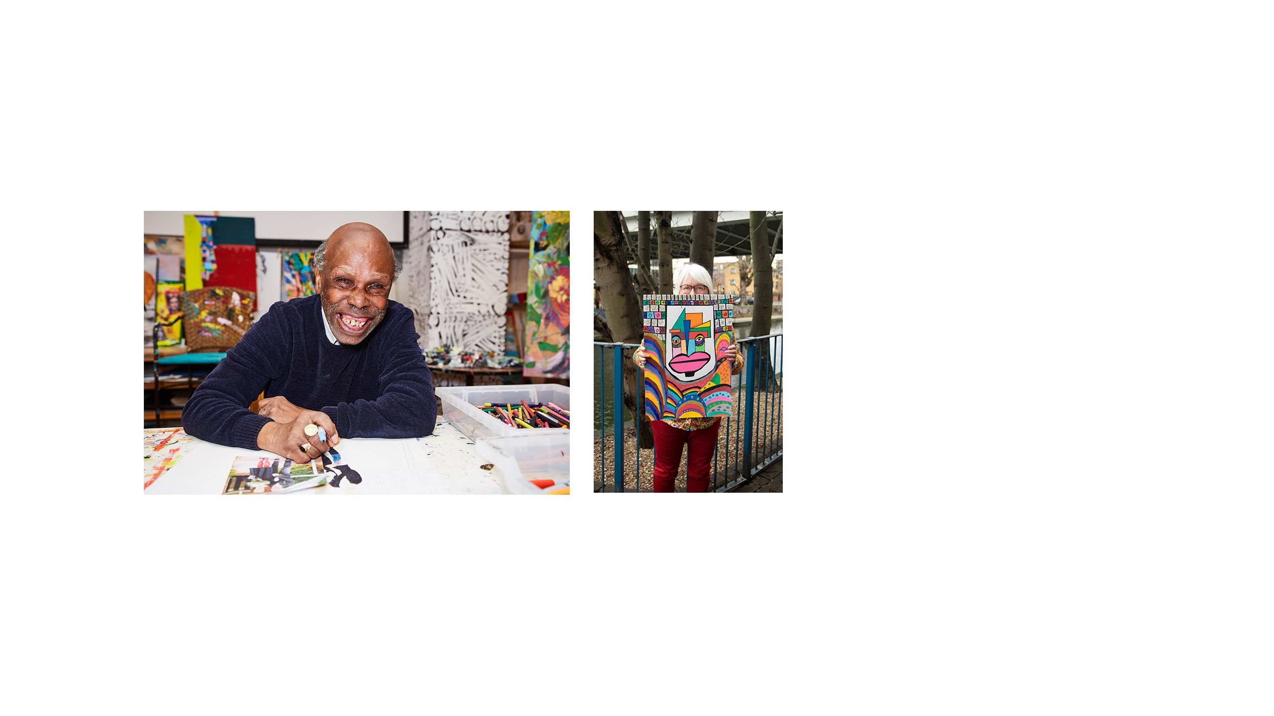 A woman stands in a park holding a vibrantly coloured painting of a face