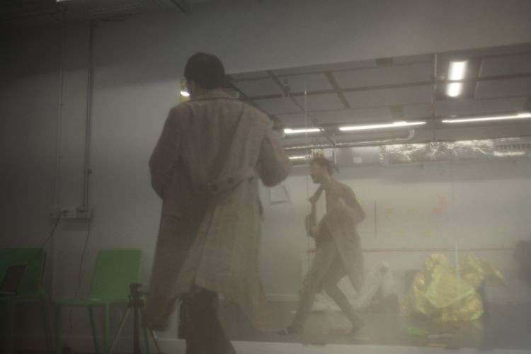 photo of a man in a rehearsal room with smoke and a mirror