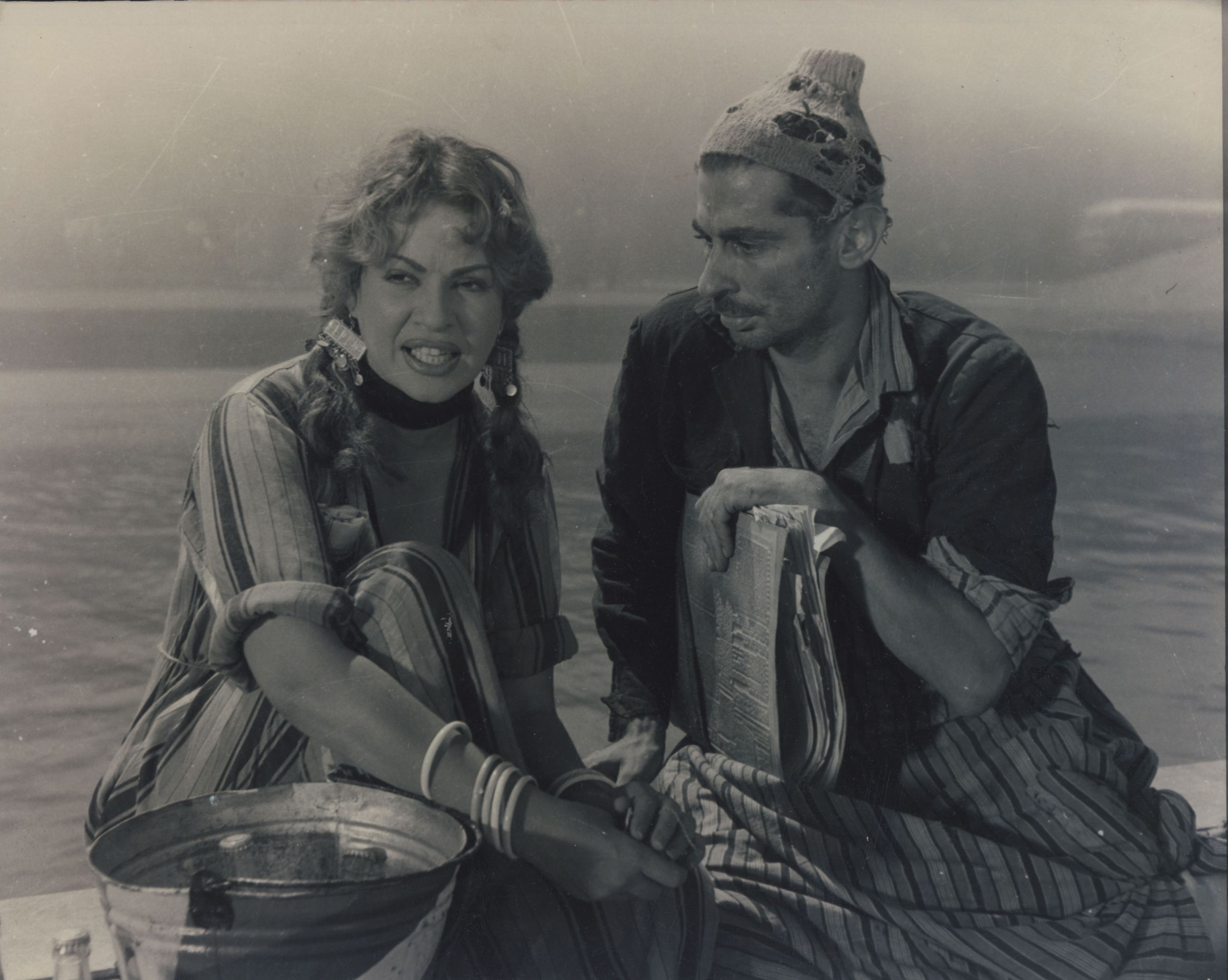 a black and white photo of a woman and man staring into the distance