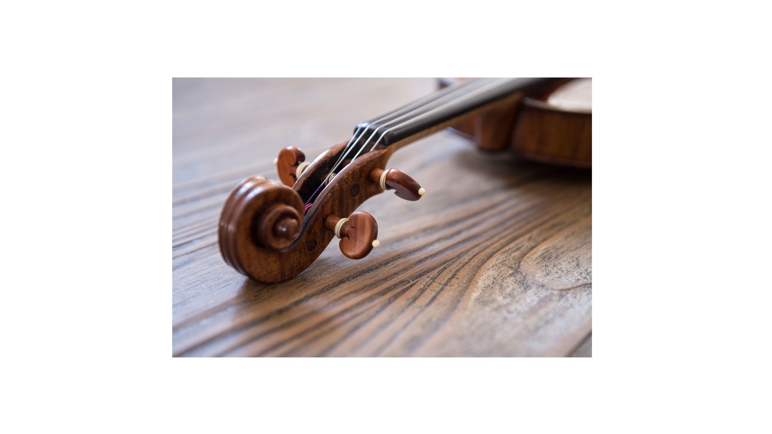 Close up of a violin on a wooden table