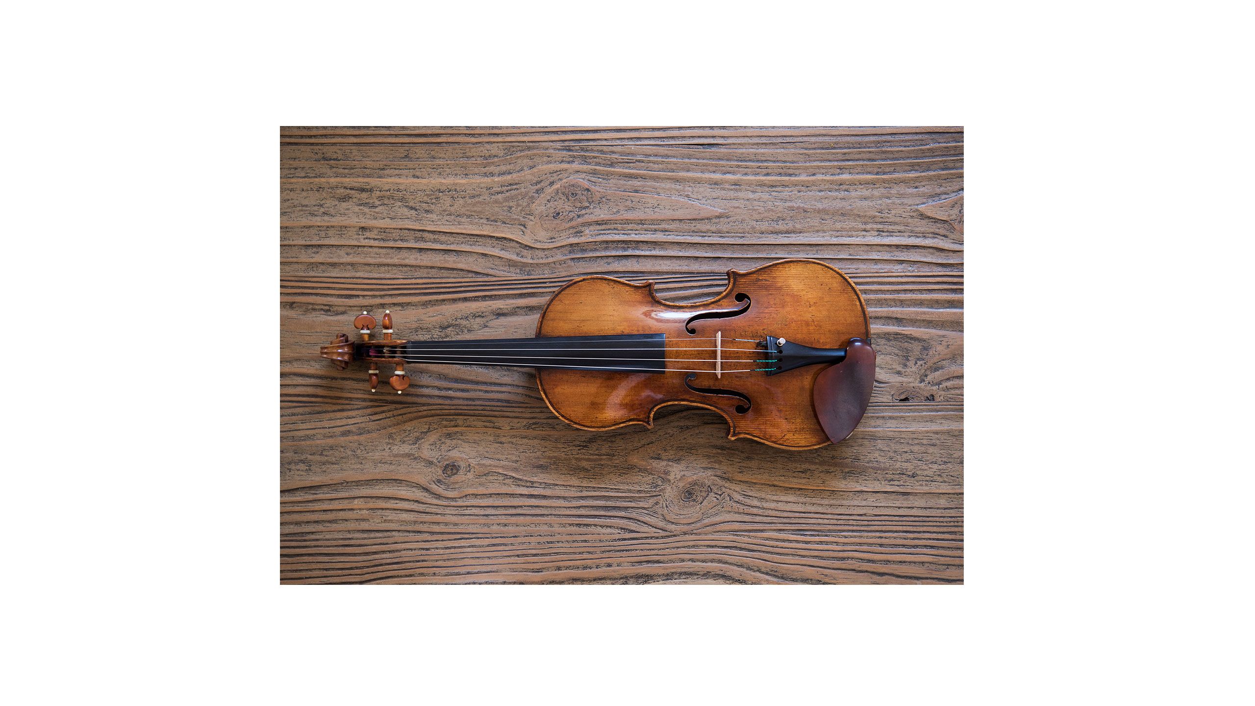 Close up of a violin on a wooden table