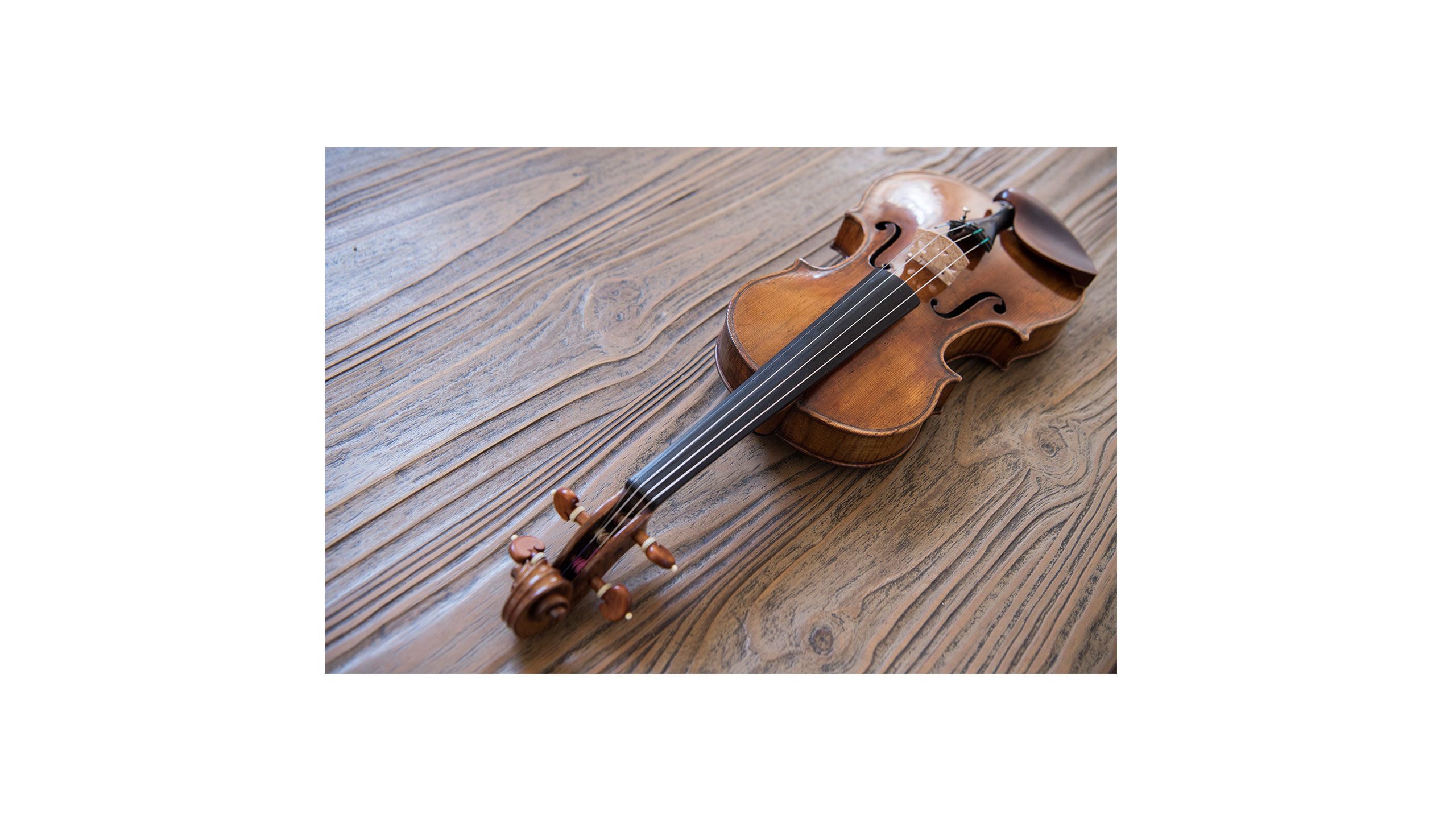 Close up of a violin on a wooden table